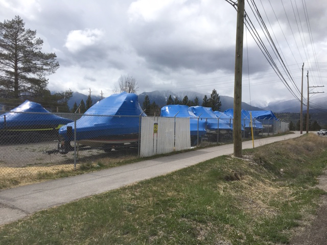 Boats covered in blue protective covers